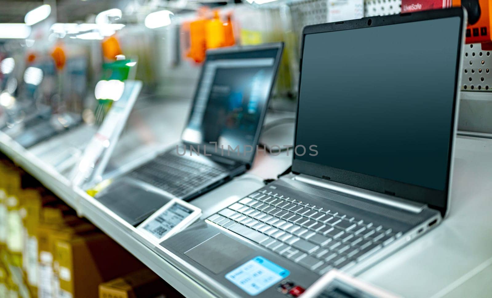 Laptop computers put up for sale in a store.