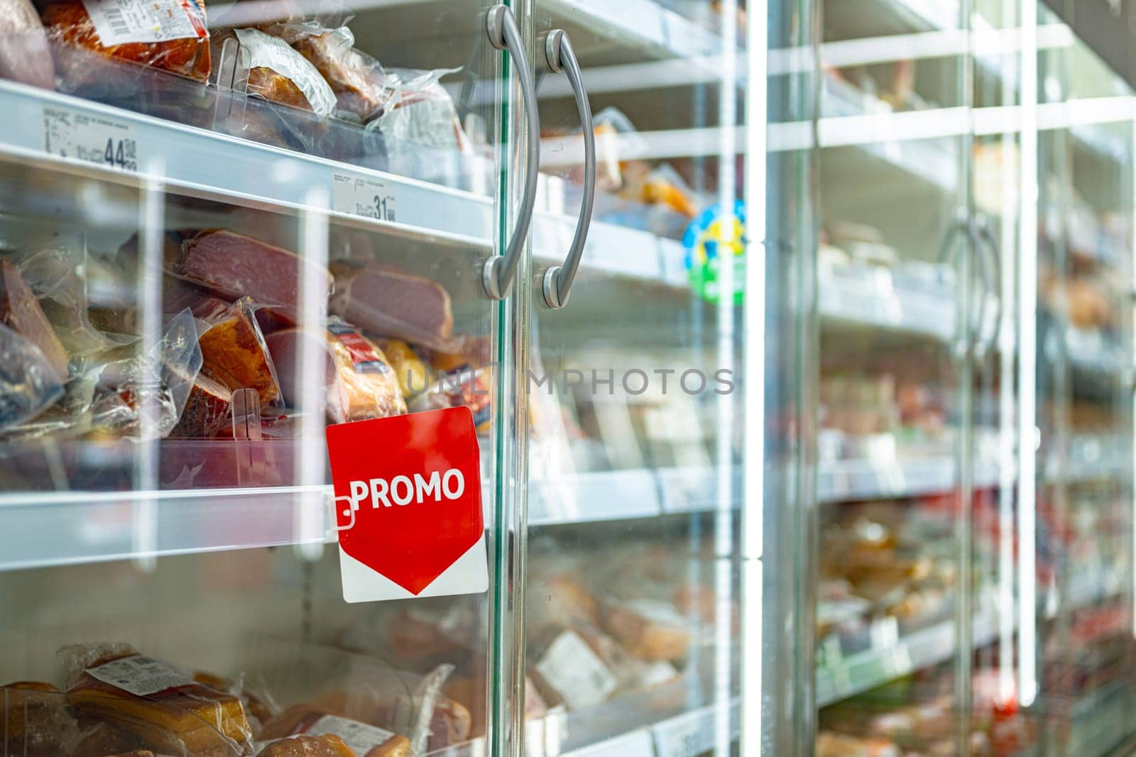 Promo sign at a commercial refrigerator in a supermarket.