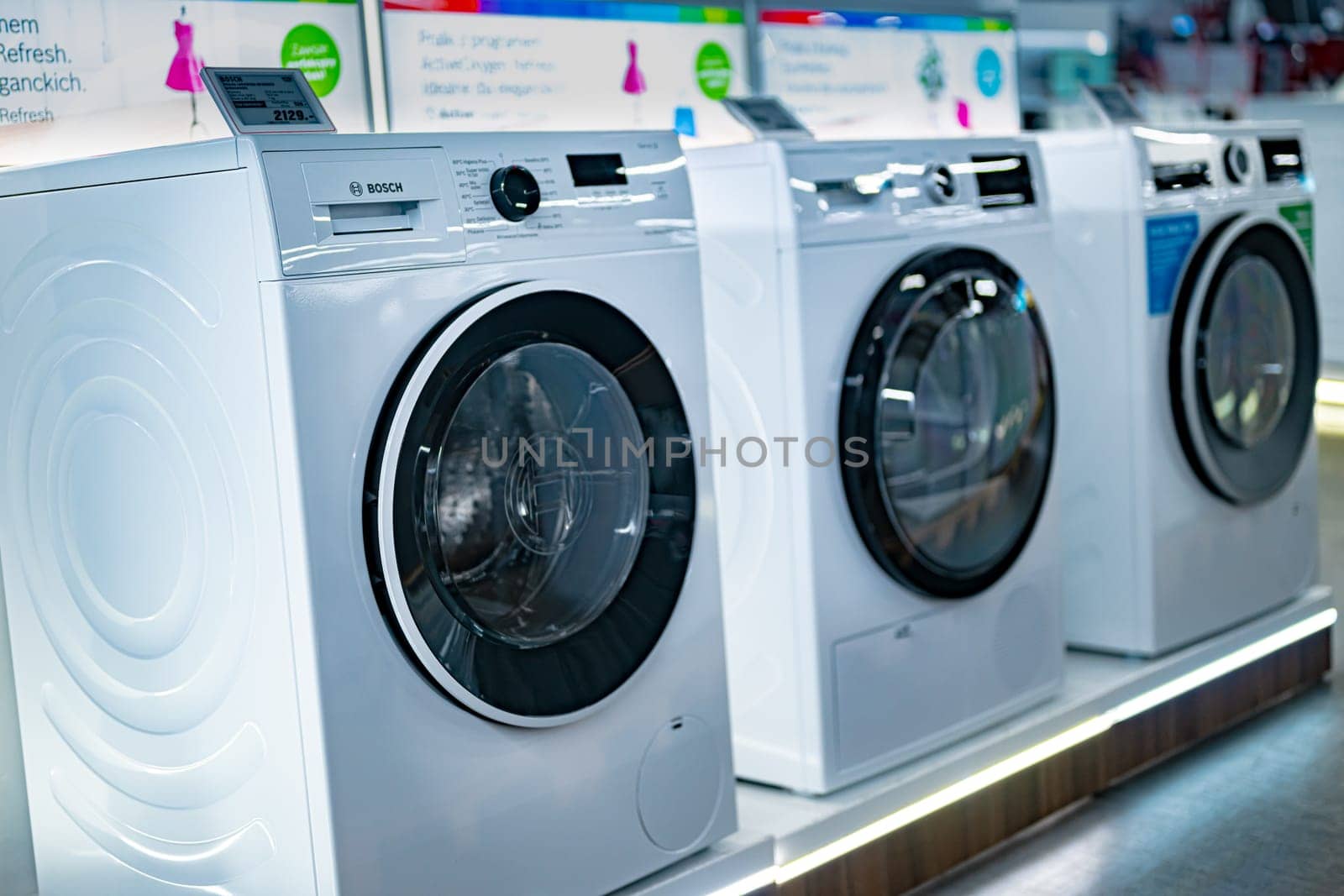 POZNAN, POL - DEC 5, 2024: Front-loader washing machines by Bosh put up for sale in a household goods store