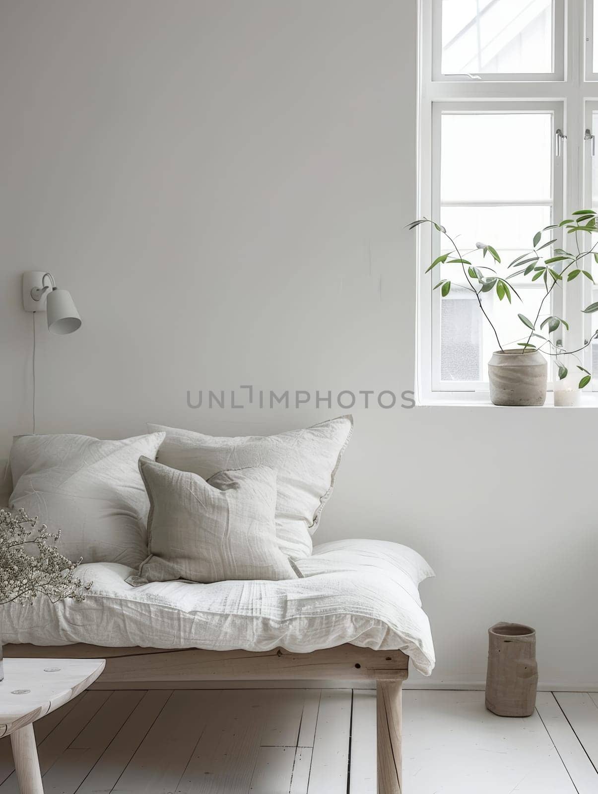 Minimalist corner with a comfy white daybed and tranquil window view, embodying simplicity