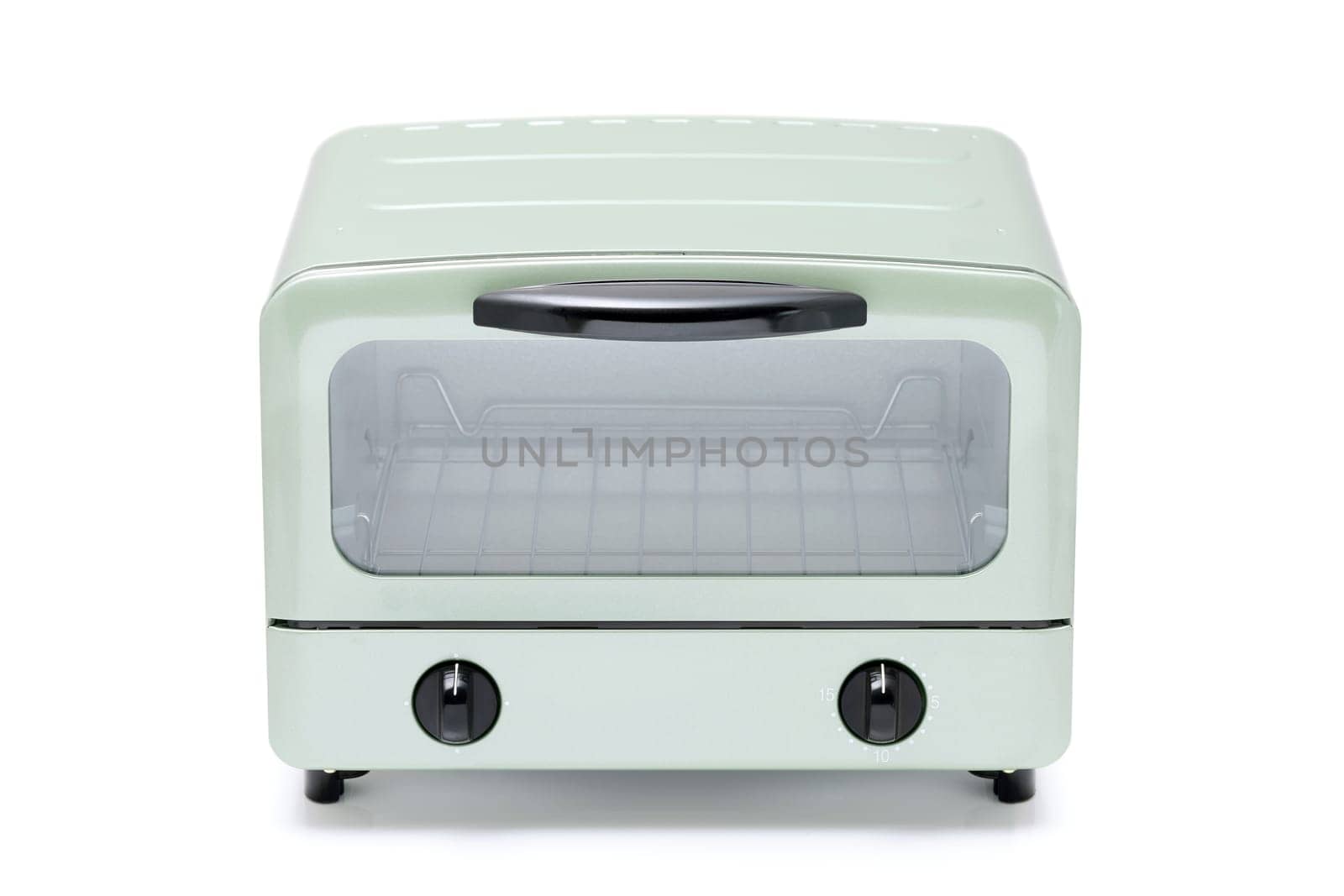 Close-up of a modern toaster oven with dials, compact kitchen appliance.