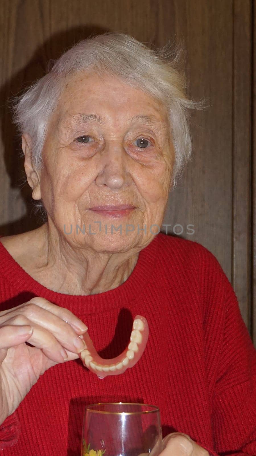 flexible nylon denture on senior female hands. Removable dentures flexible, devoid of nylon, hypoallergenic exempt from monomer