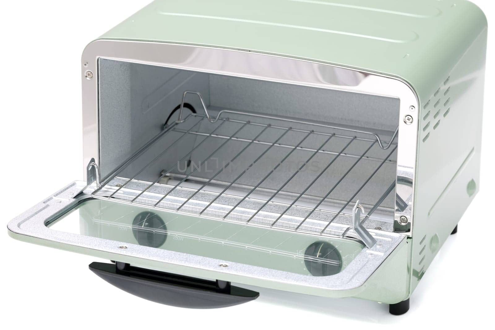 Close-up of a modern toaster oven with dials, compact kitchen appliance.