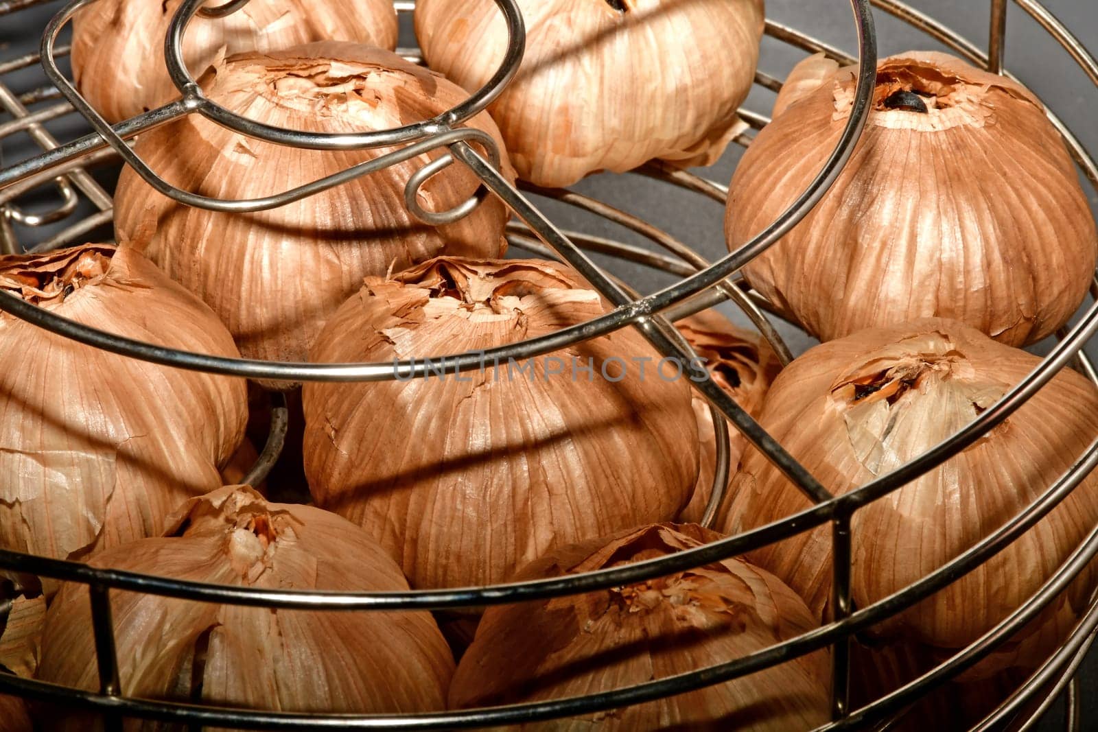 black fermented garlic in a grid basket