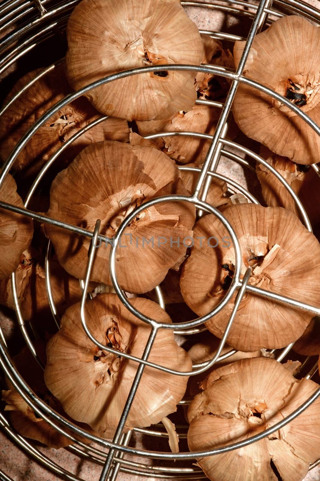 black fermented garlic in a grid basket