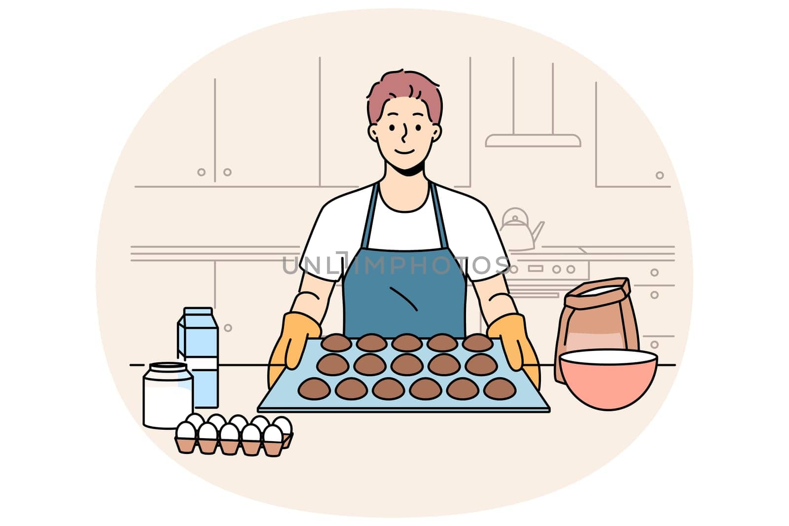 Man baker prepares oatmeal cookies or gingerbread while standing near kitchen table with ingredients. Baker guy dressed in apron and gloves proudly demonstrates dessert ready for baking.