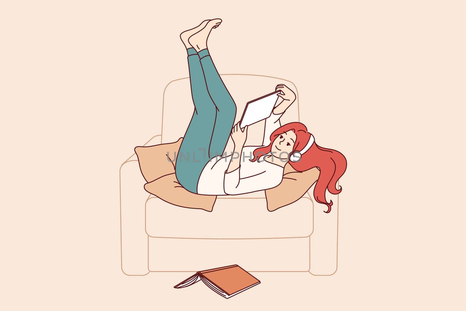 Lazy girl student listens to music lying in chair, distracted from reading textbook to prepare for exams. Lazy young woman enjoying using gadgets, doing idleness after hard day at work.