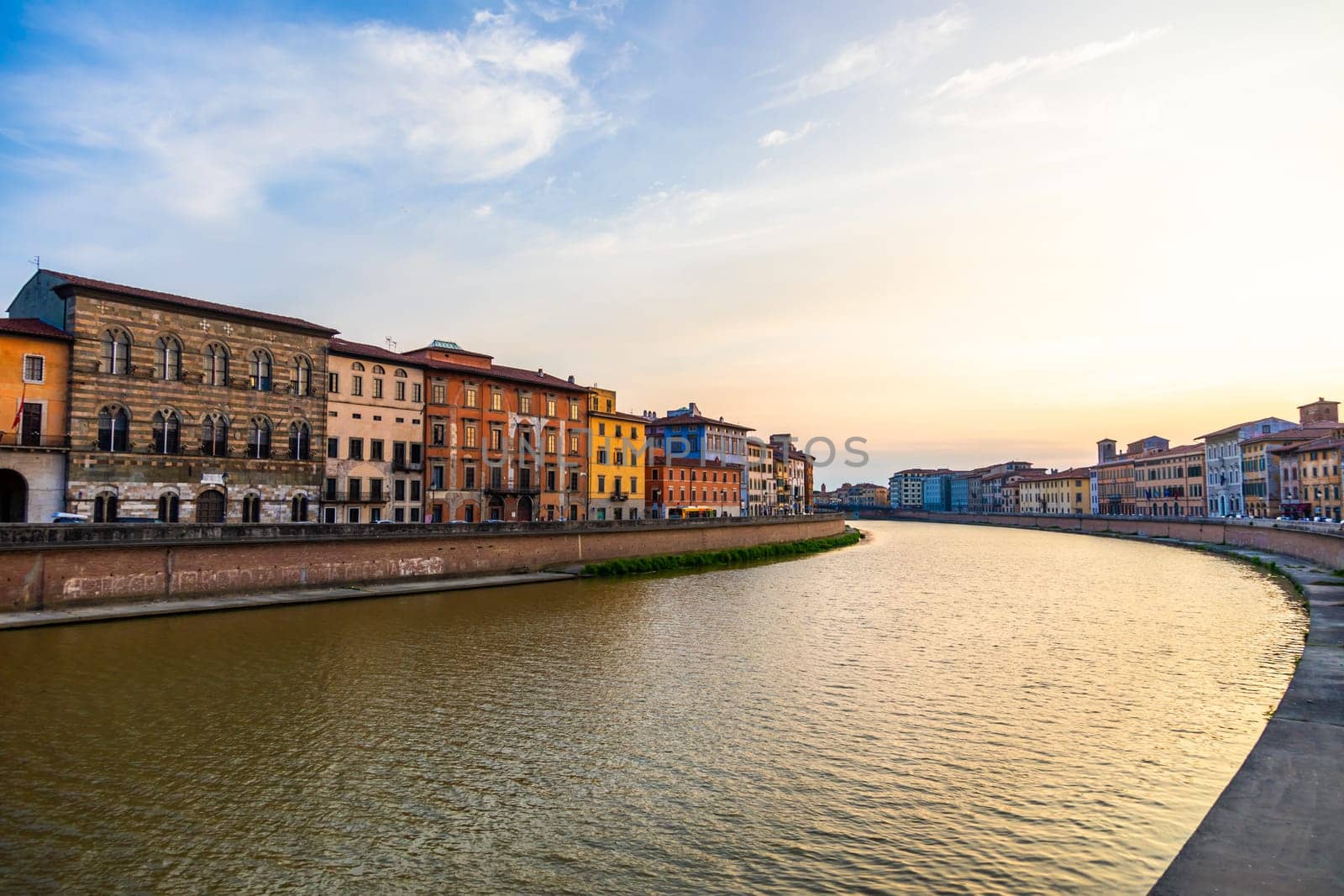 Pisa, Italy - 30 April 2024. The view of Arno river at sunset. Skyline cityscape.