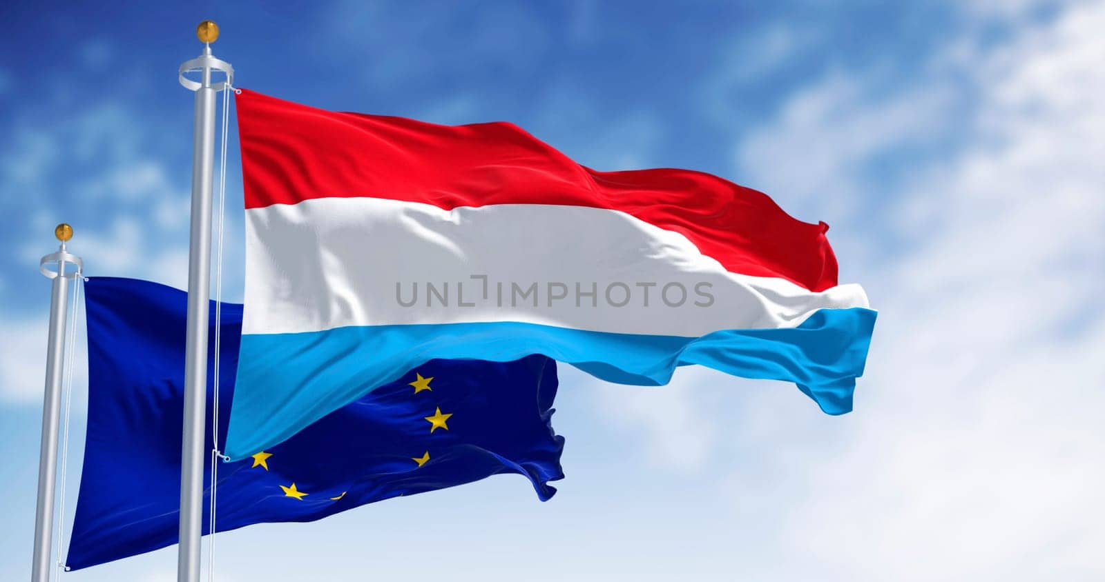 Flags of Luxembourg and the European Union waving in the wind on a clear day. 3d illustration render. Fluttering textile. Selective focus