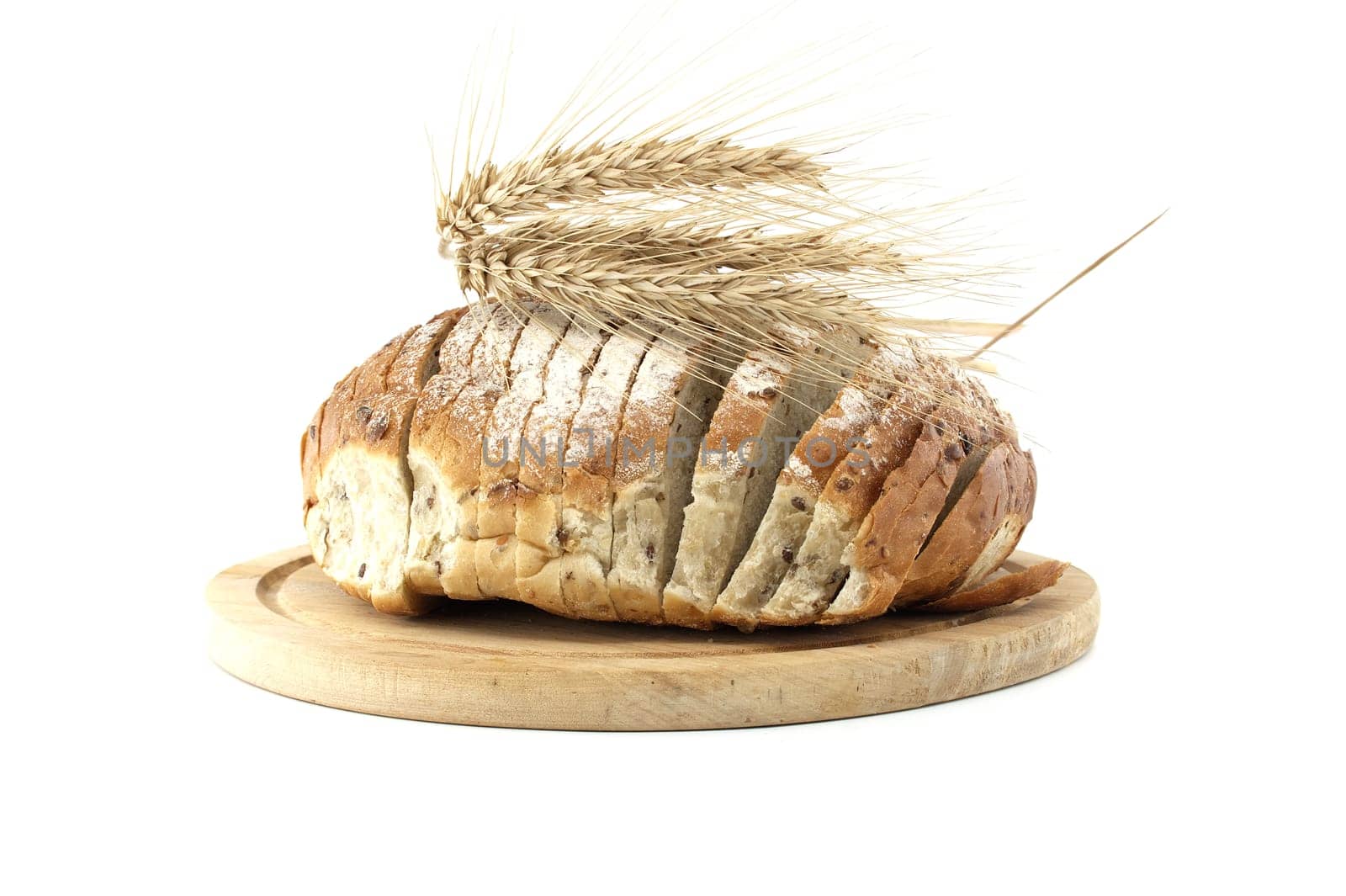 A sliced loaf of whole wheat bread displayed on a wooden board with wheat ears. Perfect for concepts related to healthy eating, baking, and organic food. Isolated on a white background