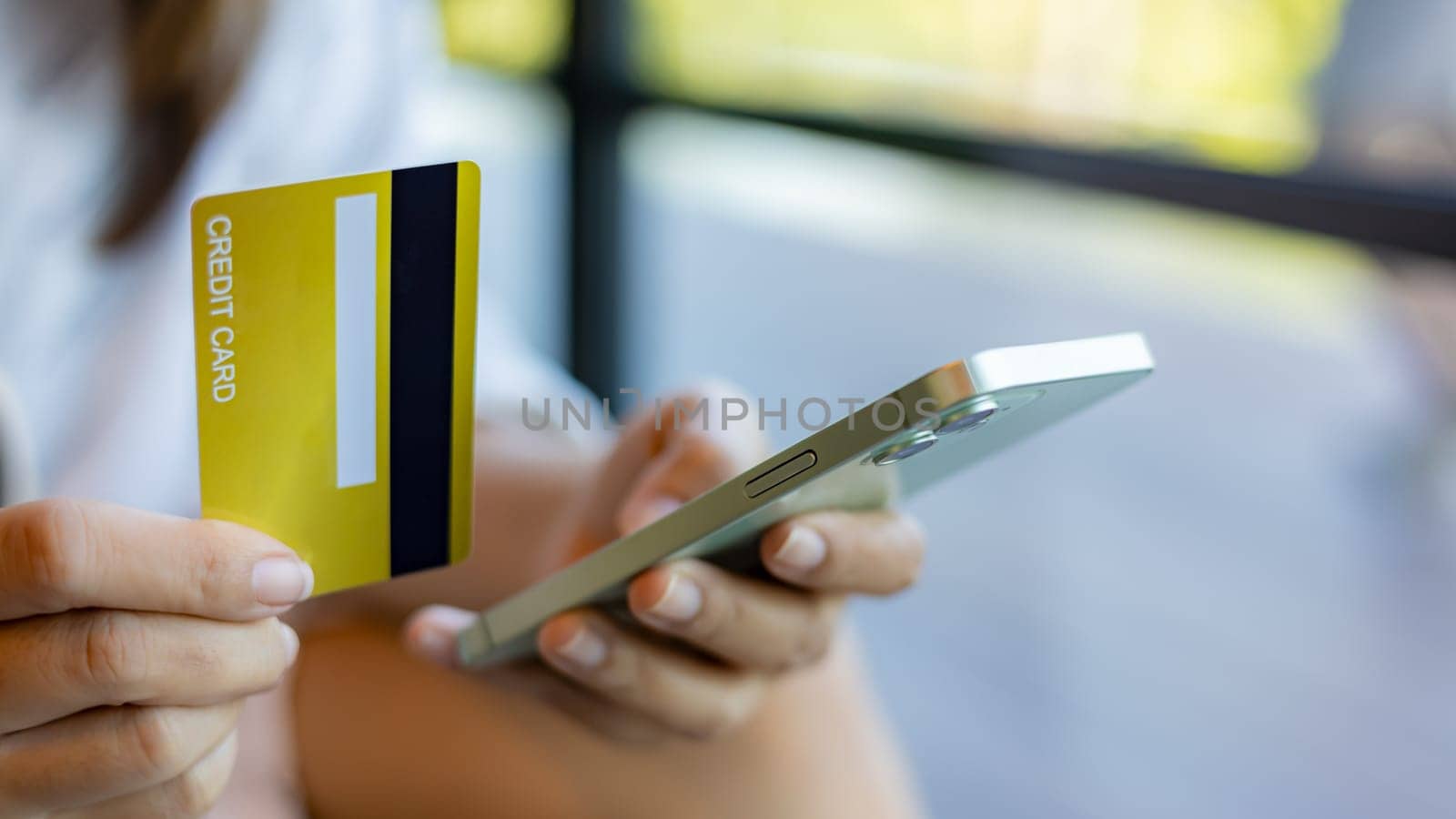 Woman with credit card using smart phone and shopping online, Online banking transaction concept, Ecommerce and secure mobile banking concept, Making online payments.
