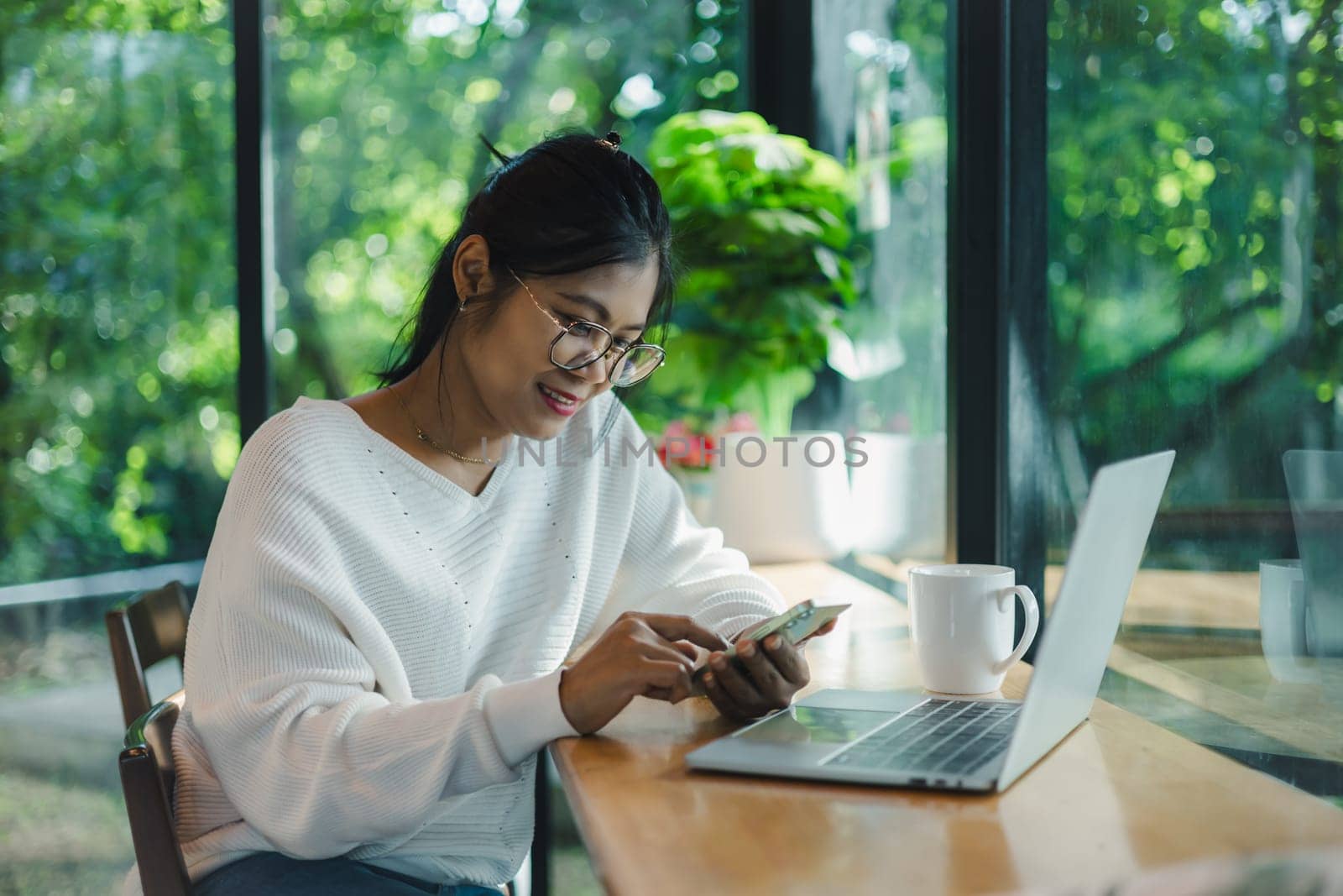 Woman working from home using laptop online meeting in home office, Happy relax time business woman typing keyboard use notebook laptop Smiling, Laughing at home office.