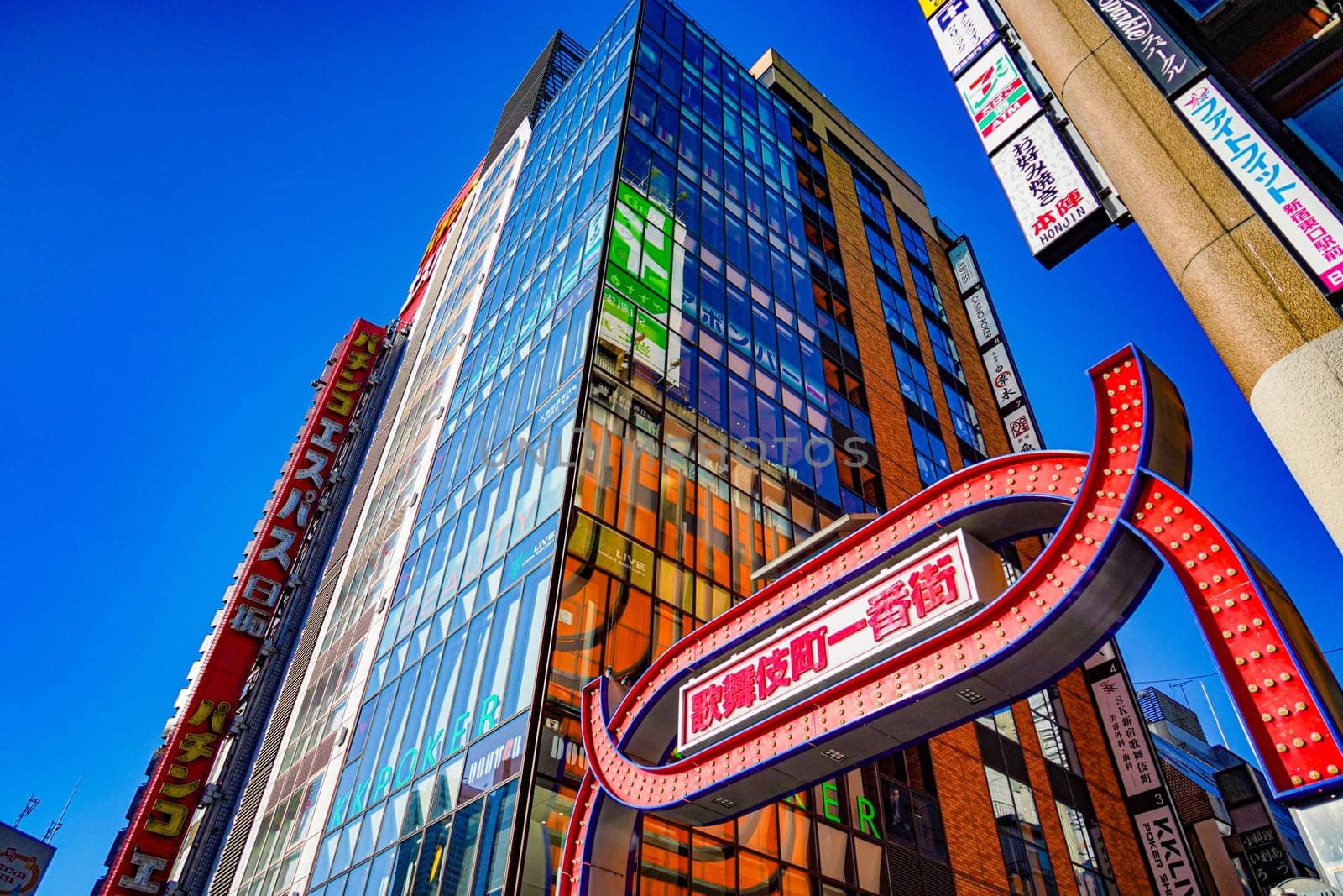 Kabukicho arch and skyscrapers. Shooting Location: Shinjuku Ward, Tokyo