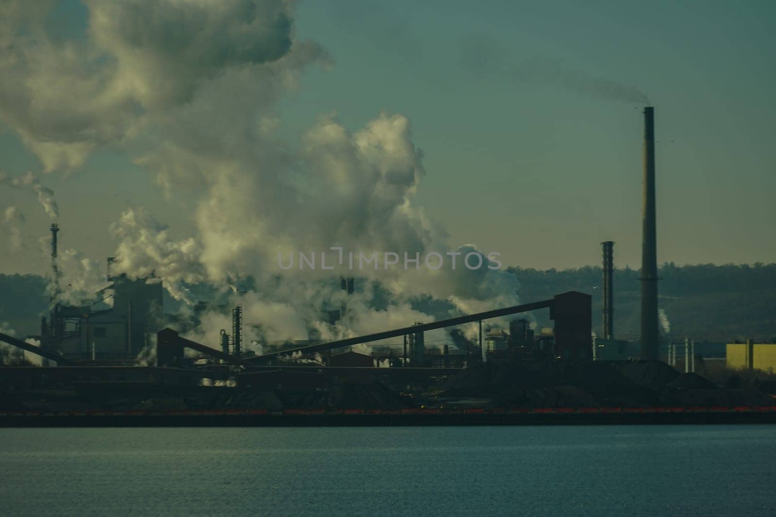 Evening view of the industrial city by the water. Shooting Location: Toronto