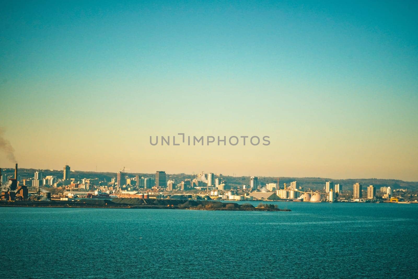 Evening view of the industrial city by the water. Shooting Location: Toronto