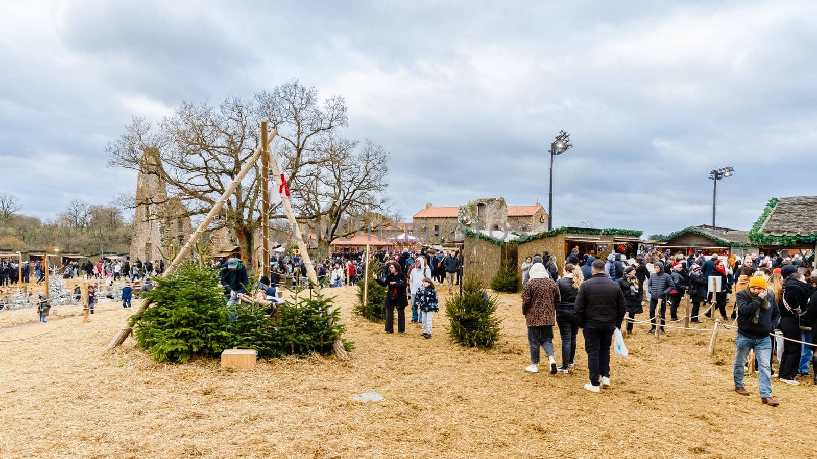 Tiffauges, Vendee, France - December 8, 2024: Street atmosphere and architecture at the Christmas Market at Tiffauges Castle on a gray winter day