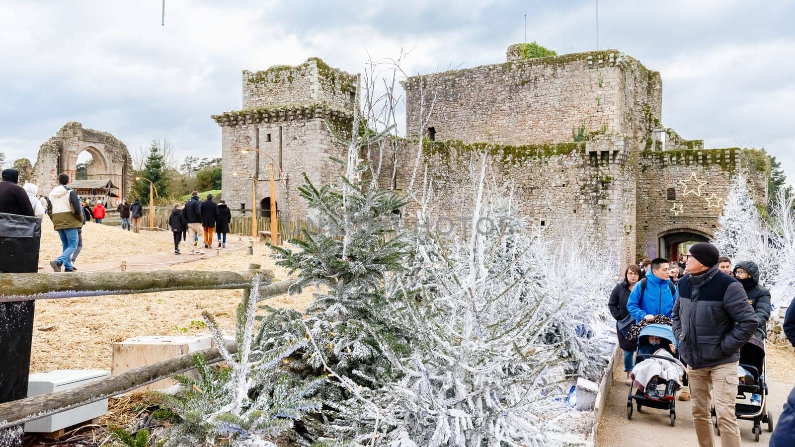 Tiffauges, Vendee, France - December 8, 2024: Street atmosphere and architecture at the Christmas Market at Tiffauges Castle on a gray winter day