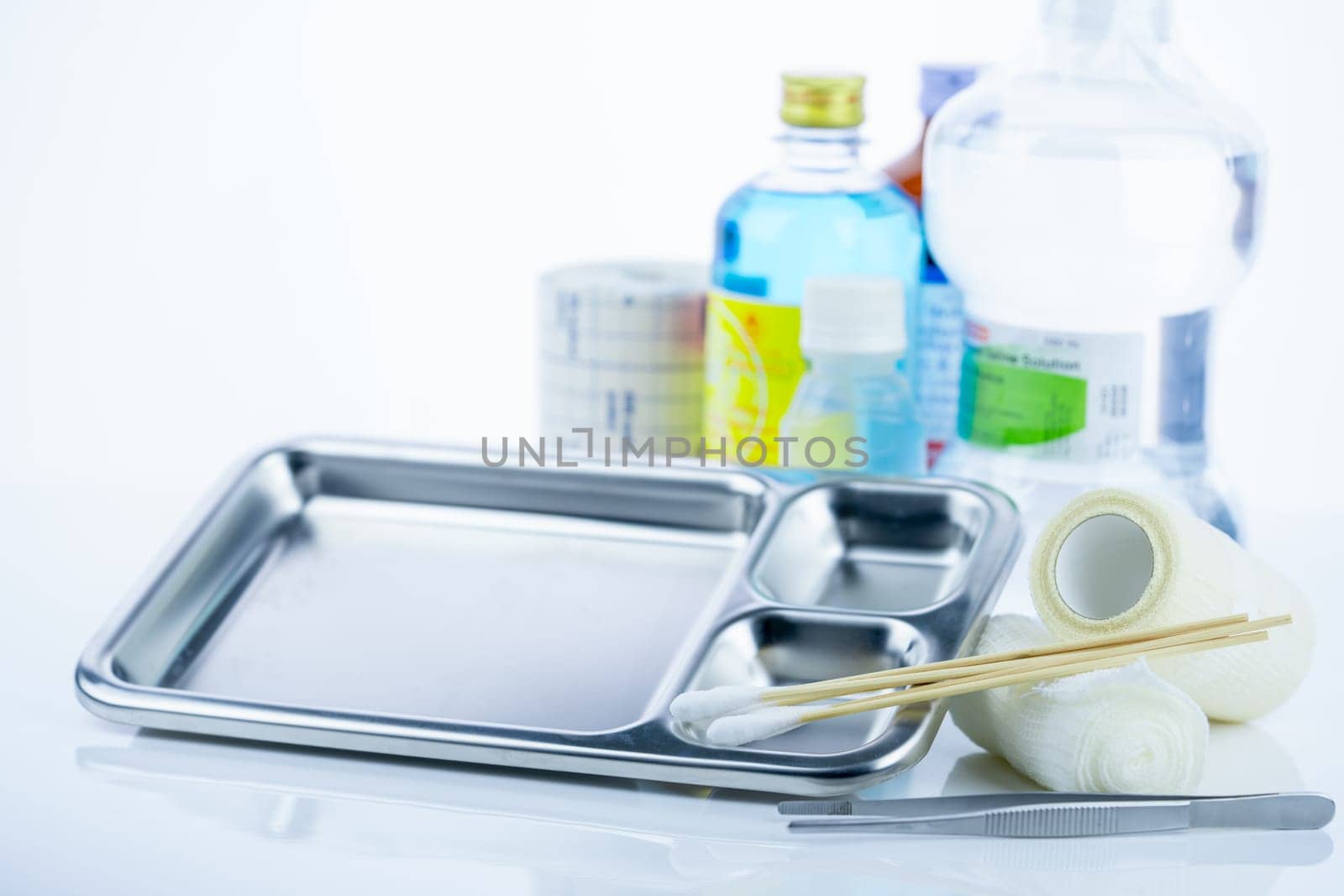 Medical equipment for treating infections. Wound care dressing set. Medical supplies for nurses. Conform bandage, forceps, cotton stick, alcohol. Sterile dressing materials. Healthcare equipment.