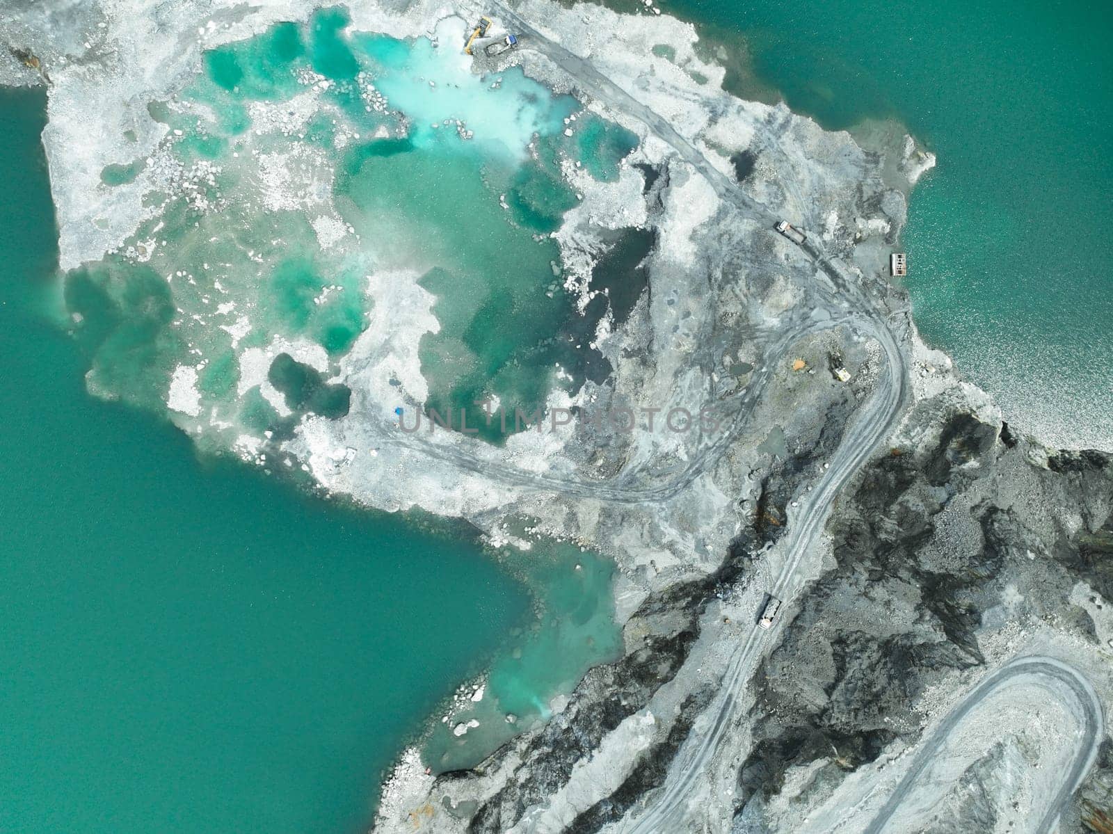 Open pit mine industry. Limestone quarry with backhoe and truck in operation. Heavy machinery in mining industry and construction material supply. Landscape of resource extraction in a industrial site