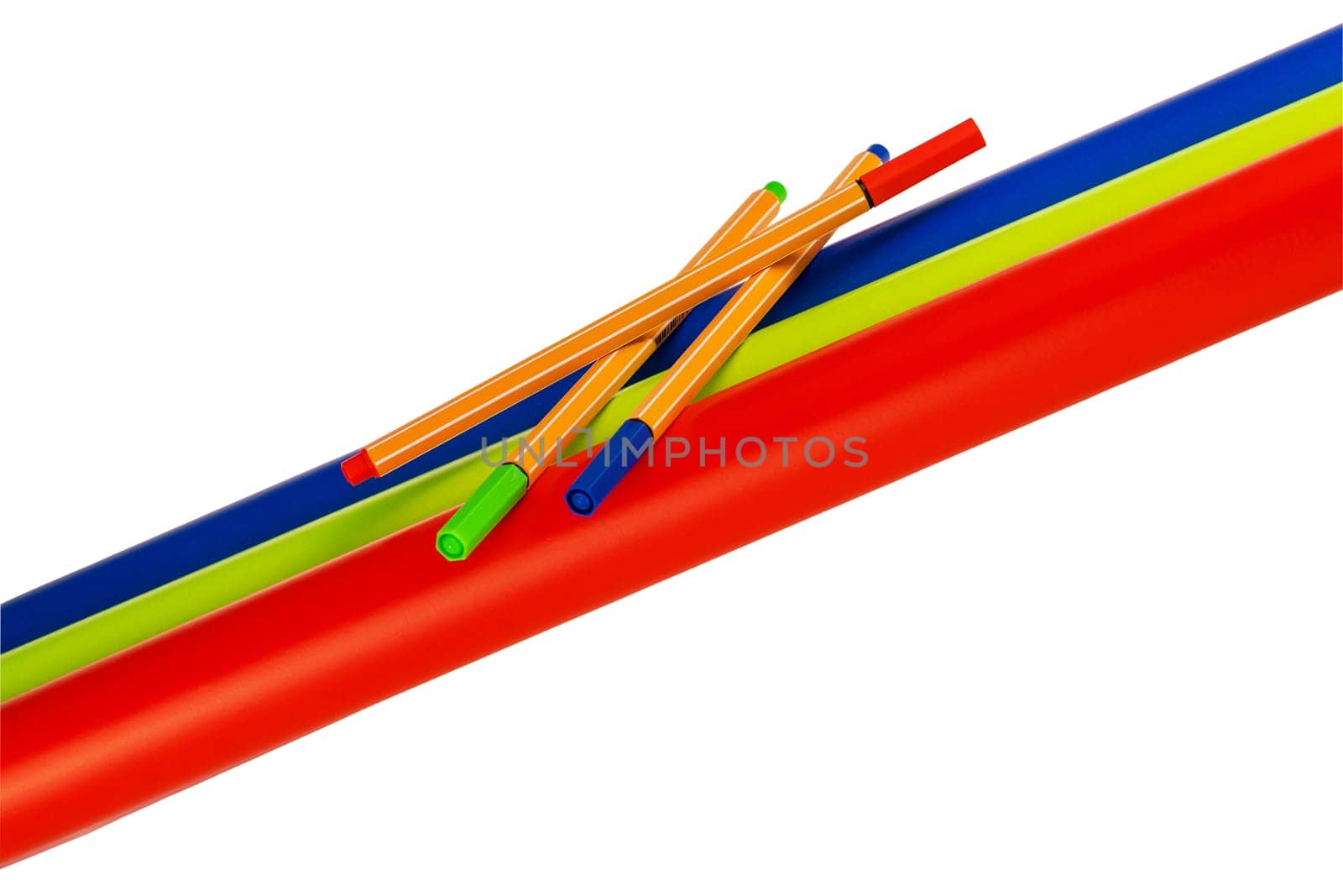Back to school. Closeup of three colored felt or marker pens on three rolls of colored paper isolated. Clipping path. Decoration element for sales of school supplies.