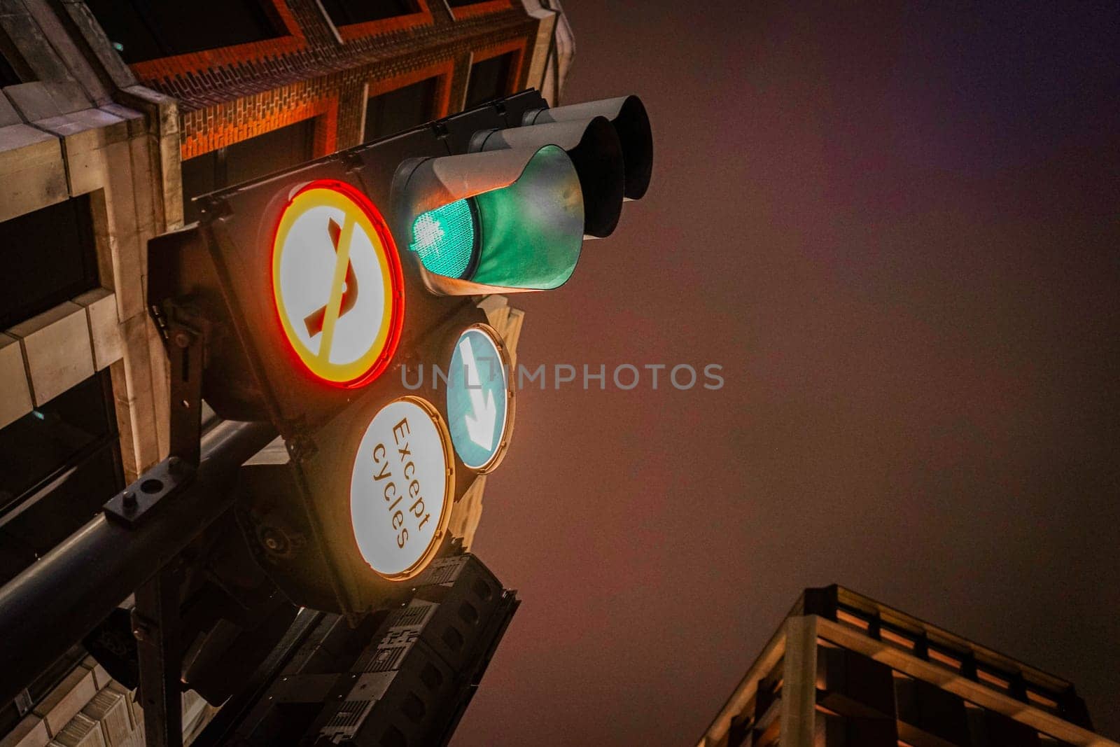 Traffic lights and buildings at night. Shooting Location: UK, London