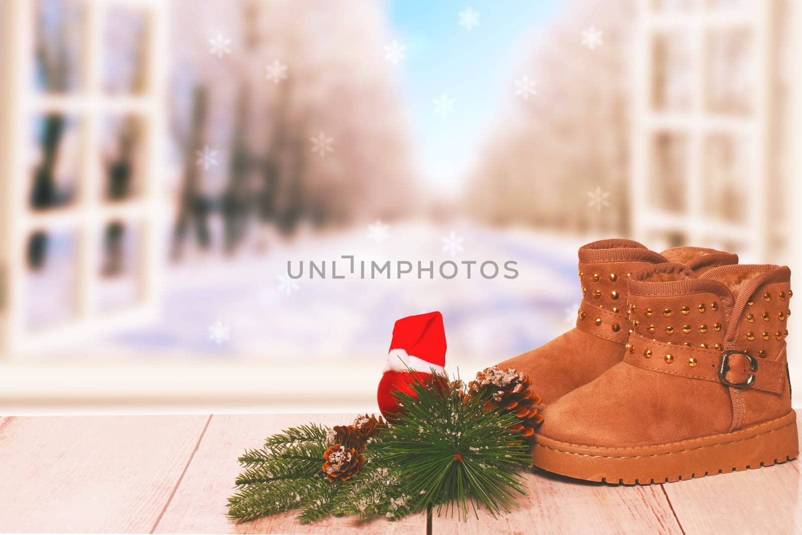 Christmas background. Table top christmas winter decoration background with an pair of winter boots over beautiful abstract winter xmas background. Card concept.