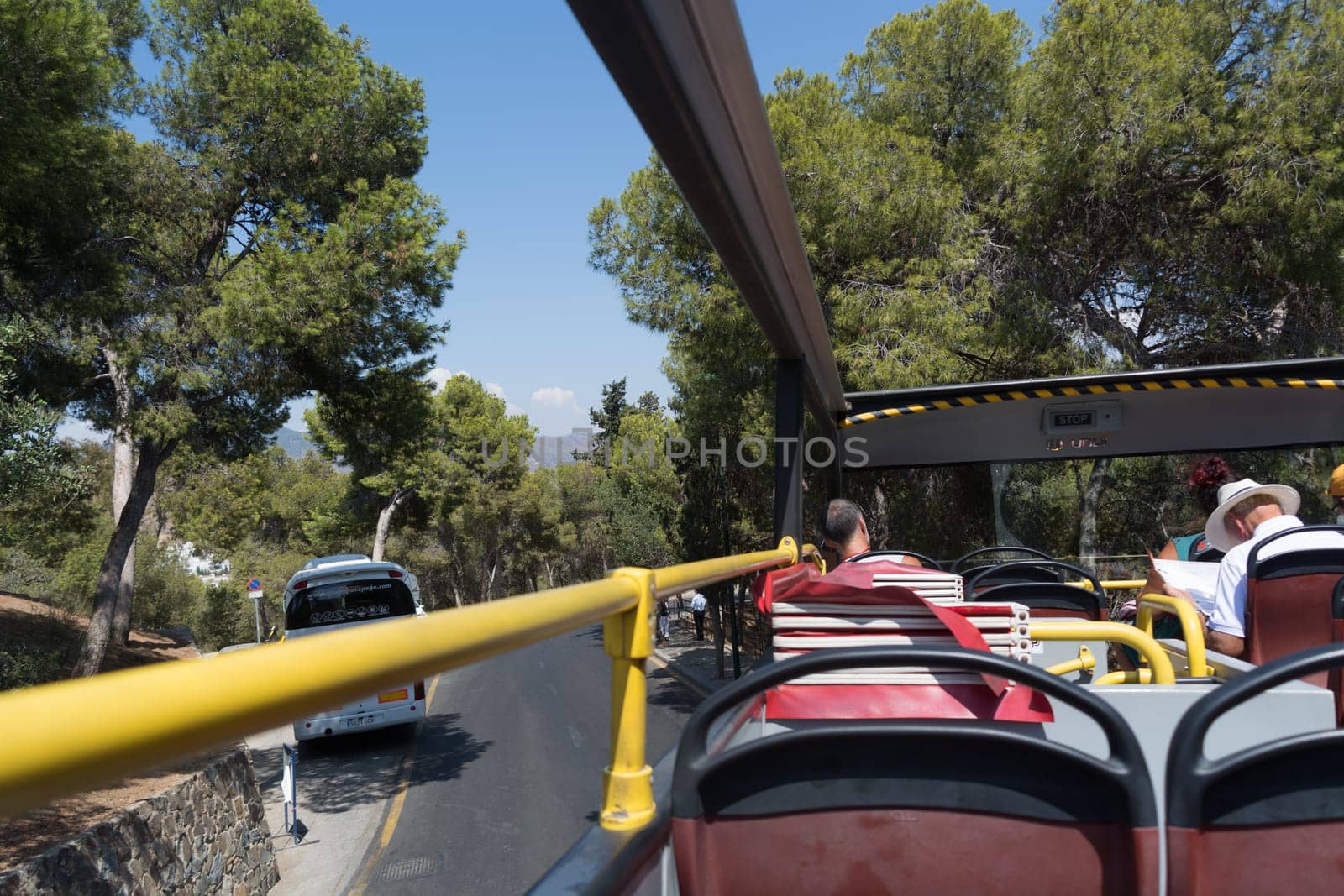 MALAGA, COSTA DEL SOL, SPAIN - AUGUST 31, 2019: Malaga, Costa del Sol, Spain - August 31, 2019: Tourist double-decker bus in Malaga, Spain. Red sightseeing bus with tourists on a sightseeing tour of Malaga.