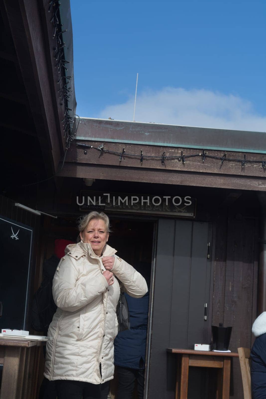 SYLT, GERMANY -MARCH  13, 2020: Sylt, Germany -March 13, 2020:  Woman at the Beach bar Sansibar, Kampen, Sylt, North Frisia, Schleswig-Holstein, Germany, Europe
