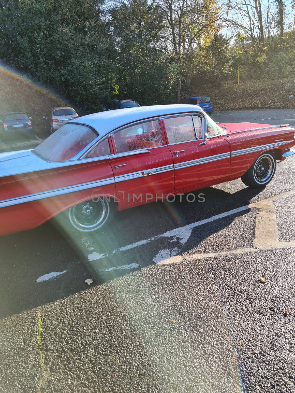 VELBERT, NRW, GERMANY - NOVEMBER 10, 2020: Velbert, Nrw, Germany - November 10, 2020: Rear view of a red colored 1960 Chevrolet Impala in a public parking lot