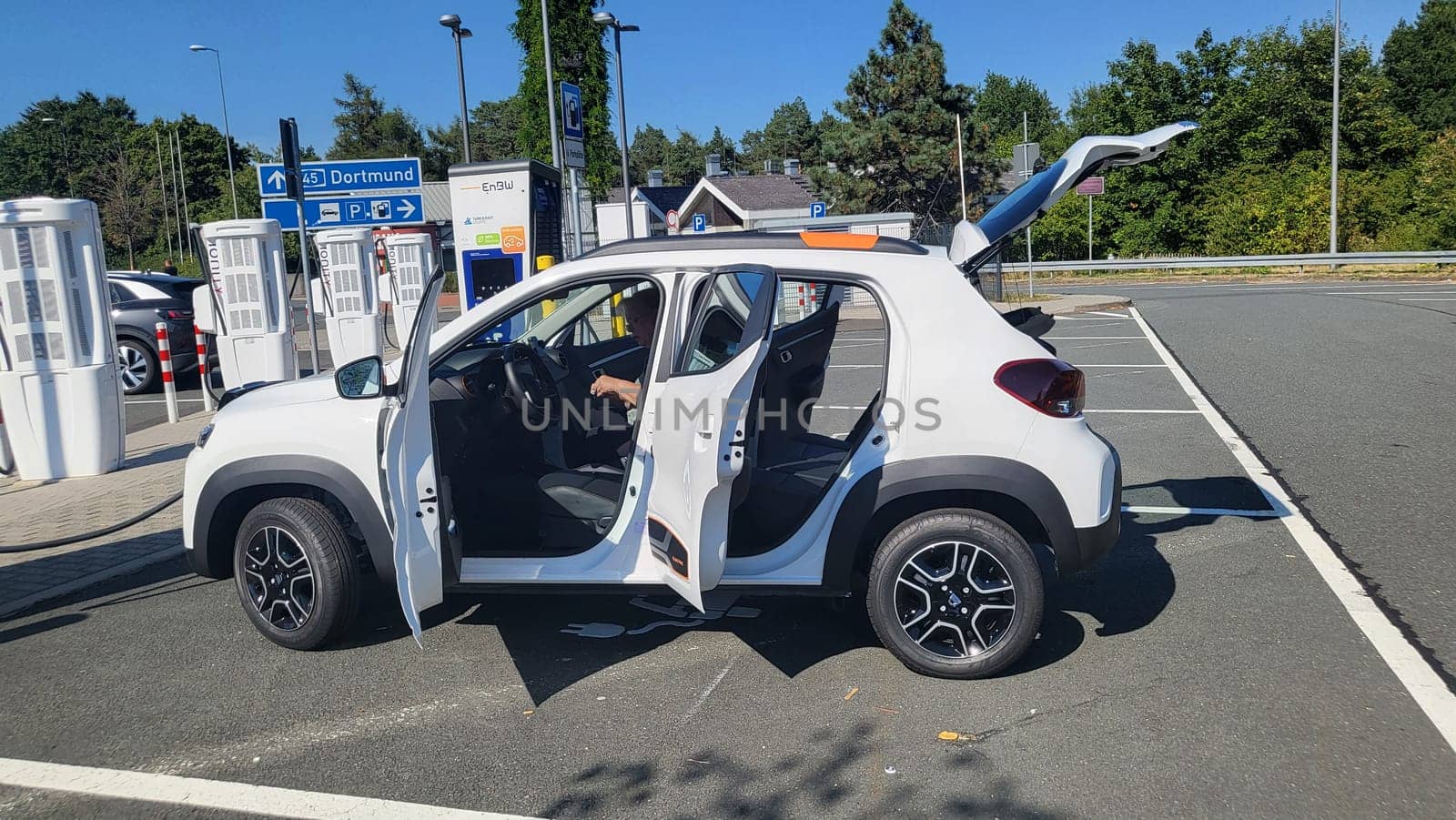 HEILIGENHAUS, NRW, GERMANY - AUGUST 10, 2022: Heiligenhaus, Nrw, Germany - August 10, 2022: Brand new electric Dacia Spring automobile being charged