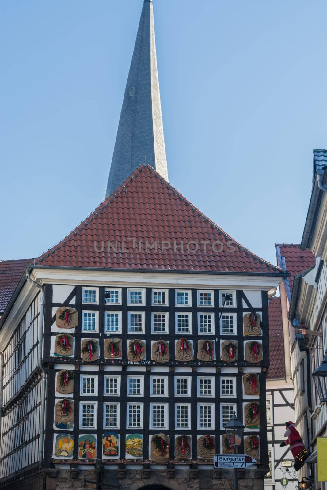 HATTINGEN OLD TOWN, NRW, GERMANY - DEZEMBER 05, 2016:  Huge Advent calendar on a half-timbered house in Hattingen. People at the Christmas market in Hattingen.