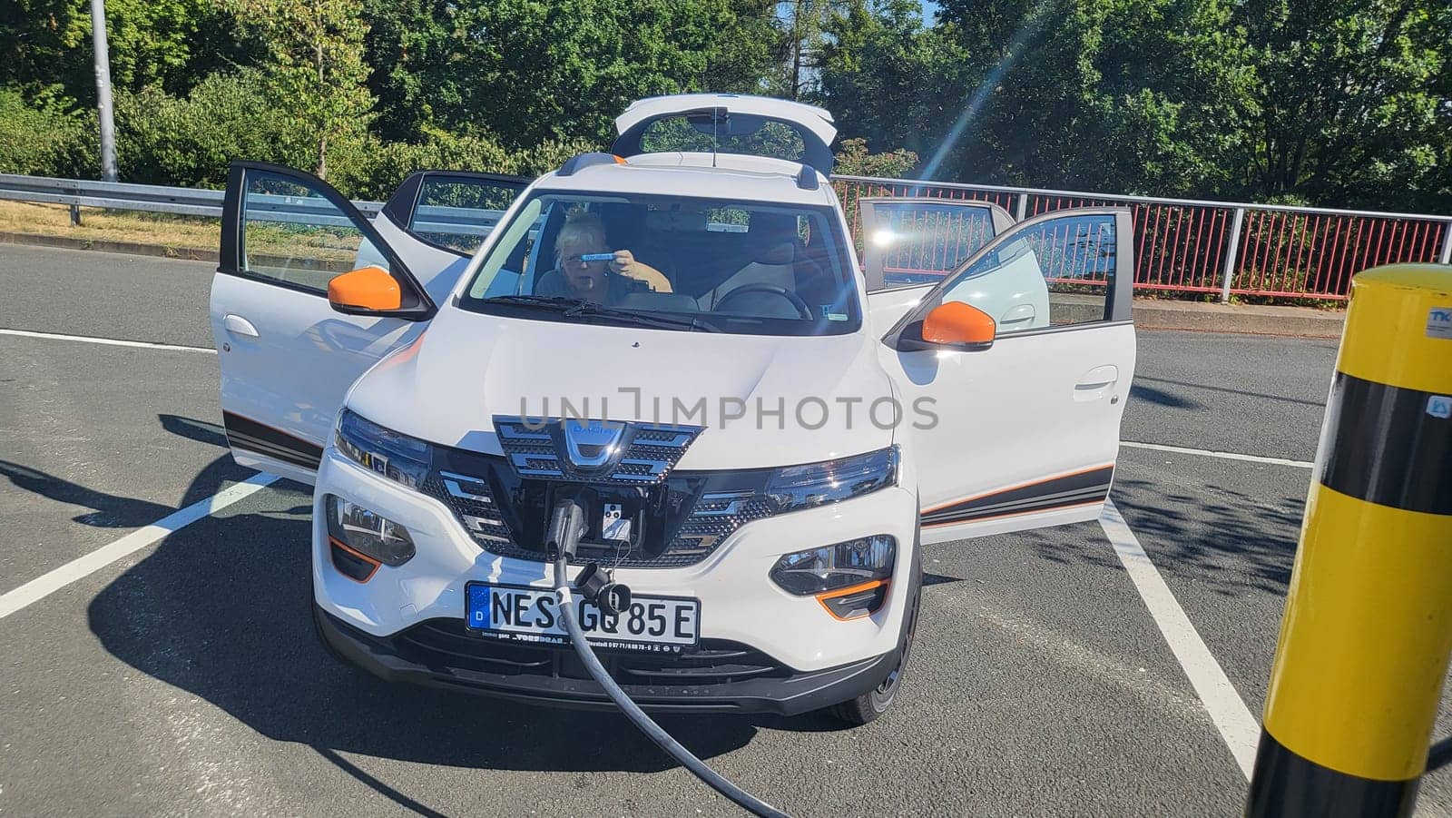 HEILIGENHAUS, NRW, GERMANY - AUGUST 10, 2022: Heiligenhaus, Nrw, Germany - August 10, 2022: Brand new electric Dacia Spring automobile being charged