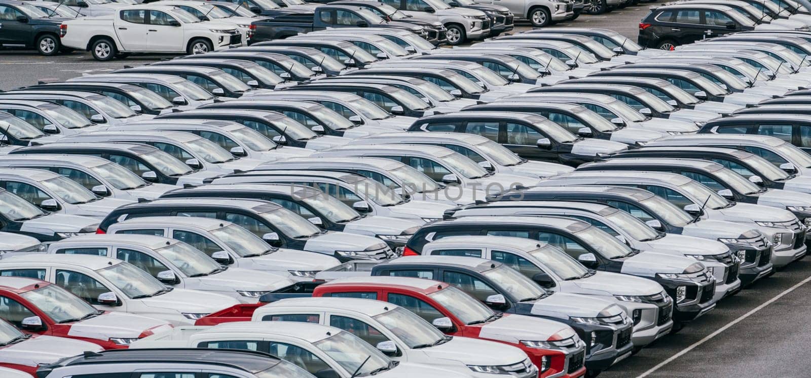Lamchabang, Thailand - July 02, 2023 Efficient loading and transportation of brand new cars from the factory's crowded warehousean essential part of global marketing.