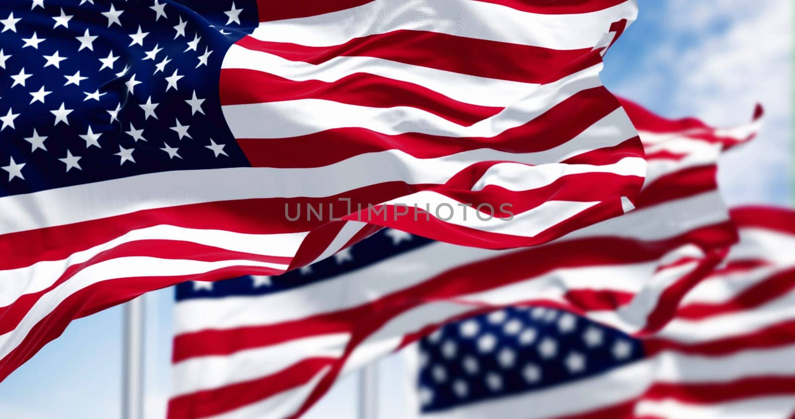 Close-up of the american national flags waving in the wind on a clear day. 3d illustration render. Selective focus.