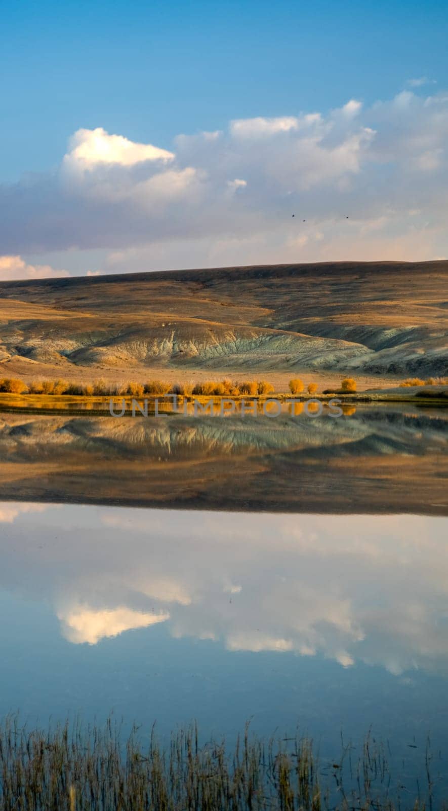 Lake in the Altai Mountains. Panorama of the Altai landscape in the mountains. The time of year is autumn.
