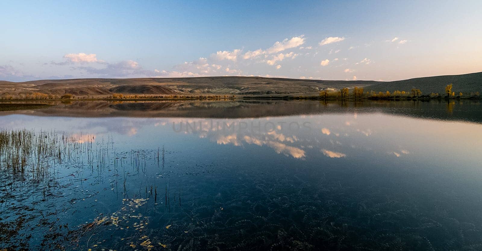 Lake in the Altai Mountains. Panorama of the Altai landscape in the mountains. The time of year is autumn.