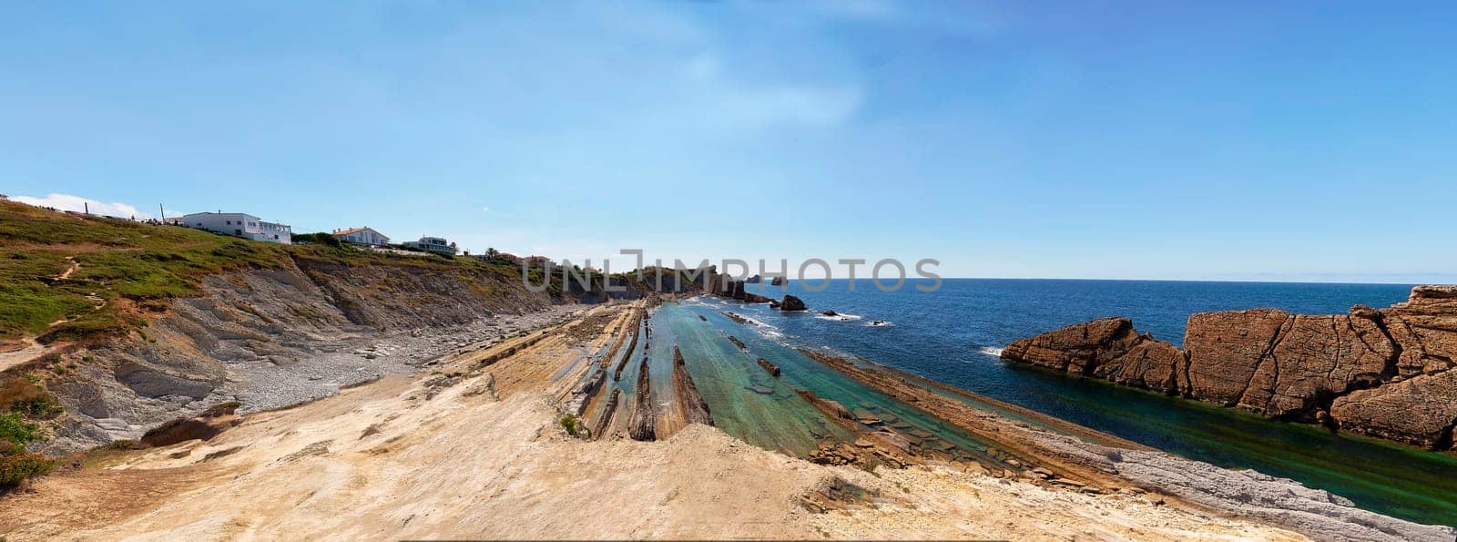 Broken coast at Liencres Cantabria , on a sunny summer day, low tide. Empty beach, low tide, clear sky, aerial view