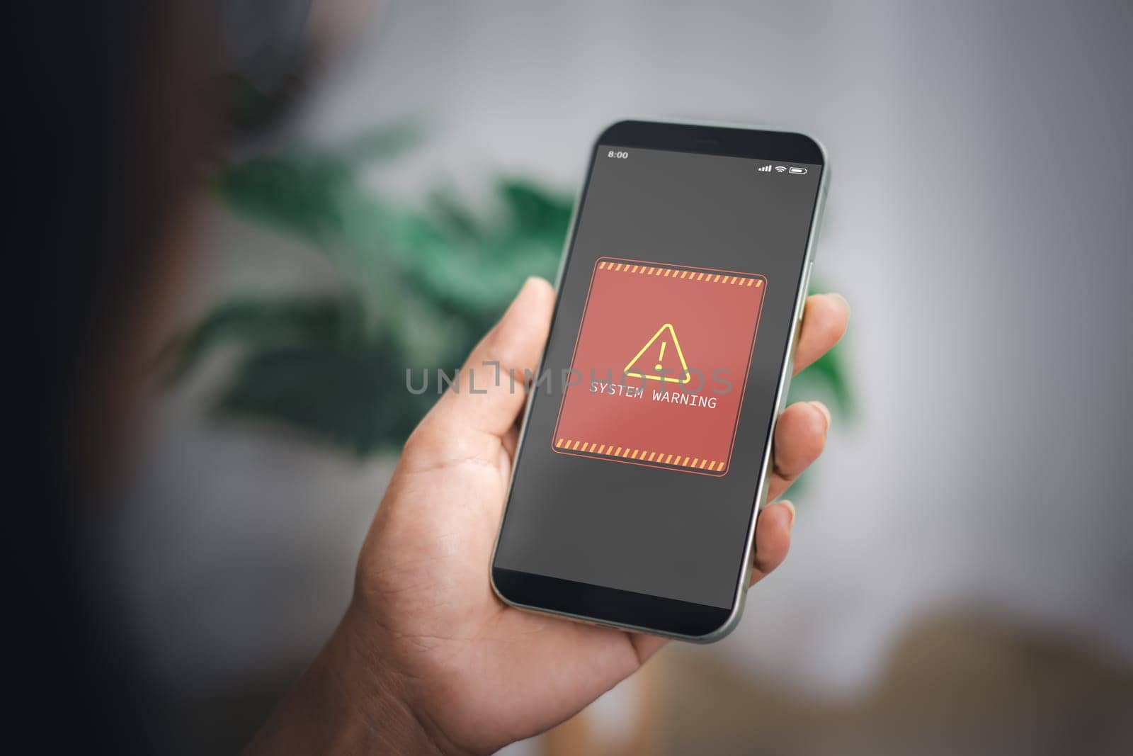 Woman shows smartphone with system hacked alert on screen. Compromised information concept. Internet virus cyber security and cybercrime. Concepts of system maintenance, Access to critical data.