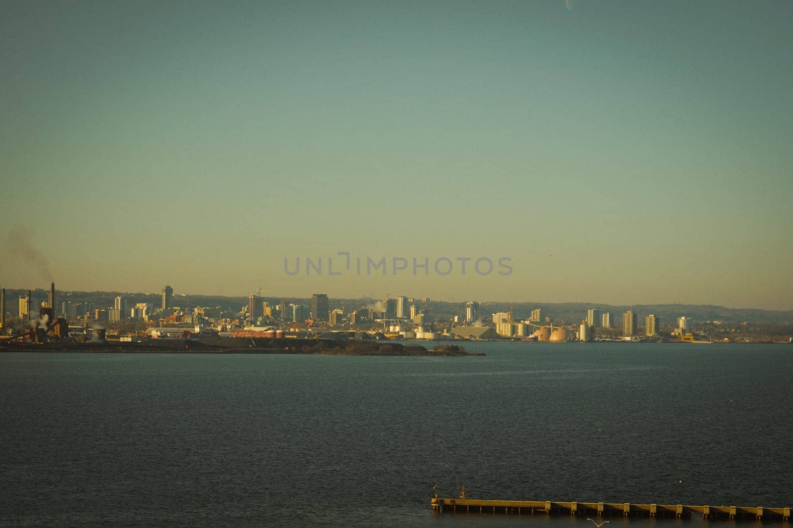Evening view of the industrial city by the water. Shooting Location: Toronto