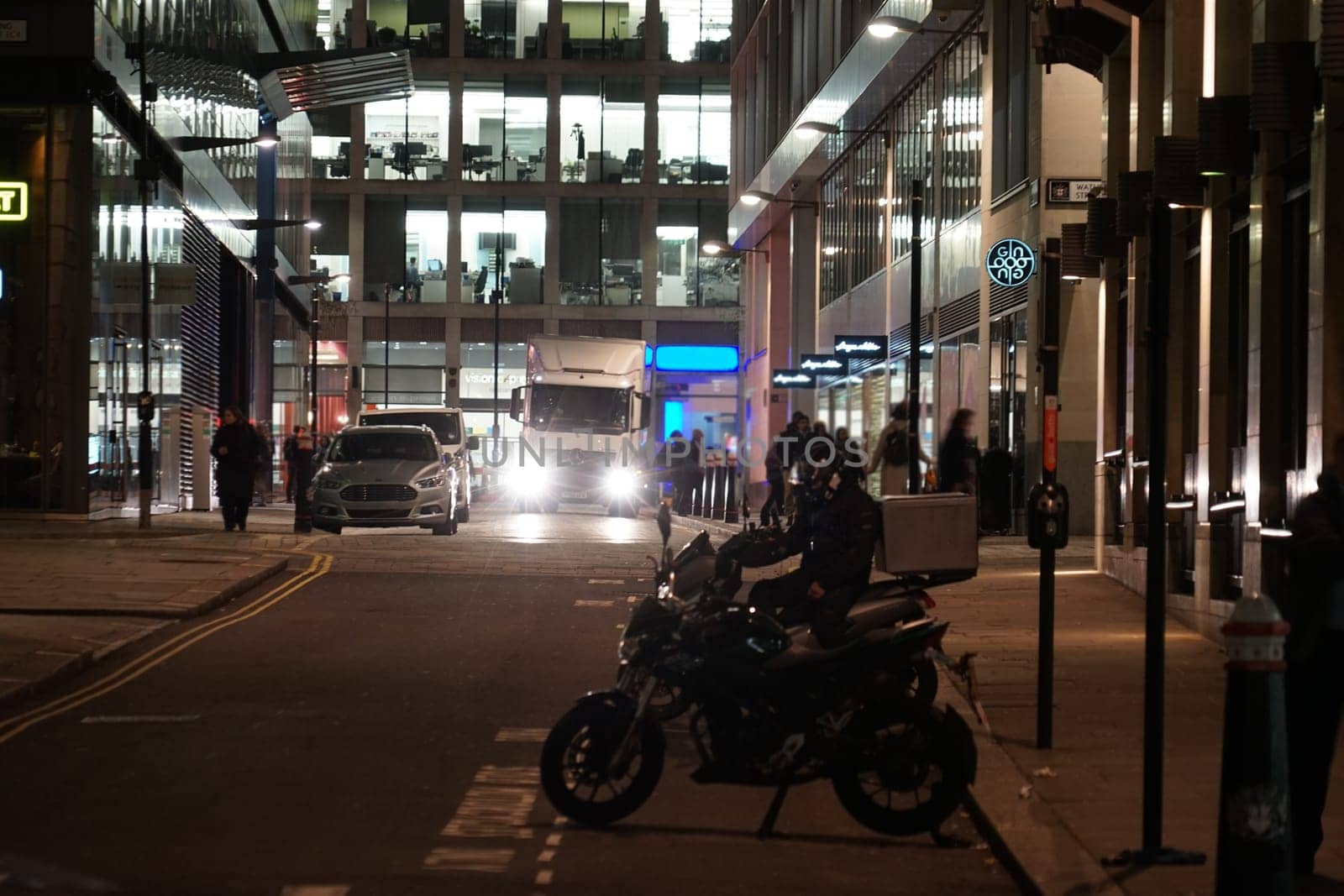 Bikes and buildings in the city at night. Shooting Location: UK, London