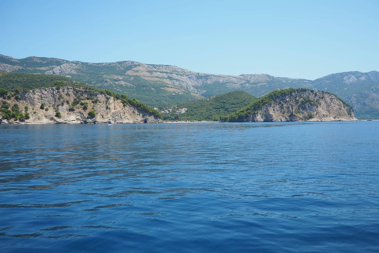 RT Dubovica Rocks near Buljarica and Svetac Rock, Montenegro. Stones inaccessible rocks. Flysch marine lithological layers. Adriatic Mediterranean sea blue water. Nature park Katici. District Budva