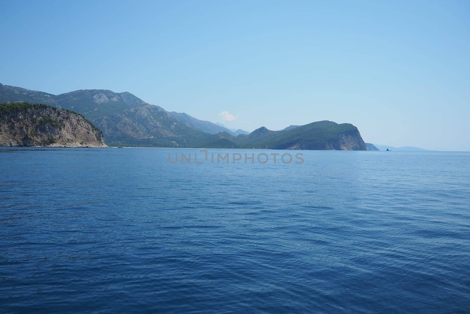 RT Dubovica Rocks near Buljarica and Svetac Rock, Montenegro. Stones inaccessible rocks. Flysch marine lithological layers. Adriatic Mediterranean sea blue water. Nature park Katici. District Budva
