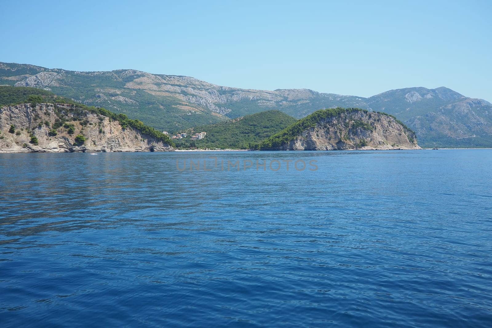 RT Dubovica Rocks near Buljarica and Svetac Rock, Montenegro. Stones inaccessible rocks. Flysch marine lithological layers. Adriatic Mediterranean sea blue water. Nature park Katici. District Budva