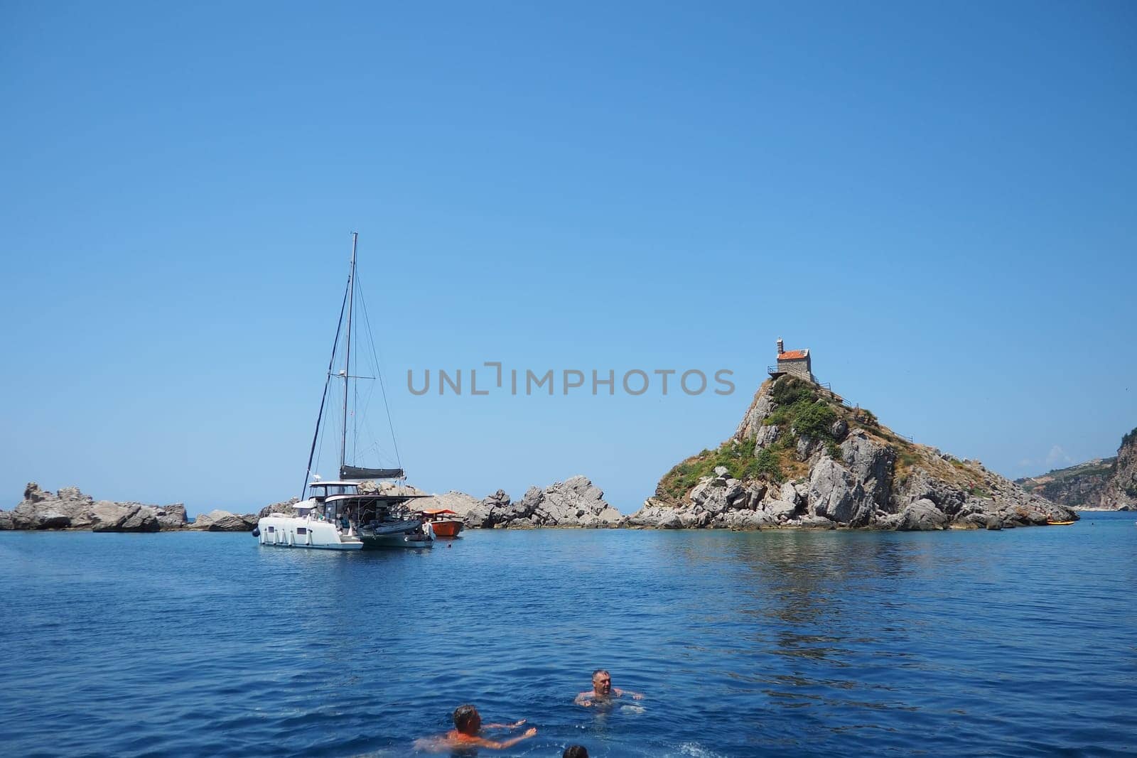 Petrovac, Montenegro, 07.27.24: Katic and Sveta Nedelja are two small islets on the Adriatic Sea, located opposite of the town of Petrovac in the Montenegrin municipality of Budva. Church on the rock.