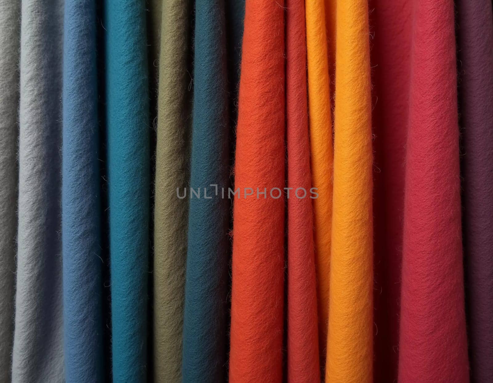 Various samples of woolen fabric in different colors are neatly organized, showcasing a vibrant palette ideal for textile design and creative projects. Generative AI.