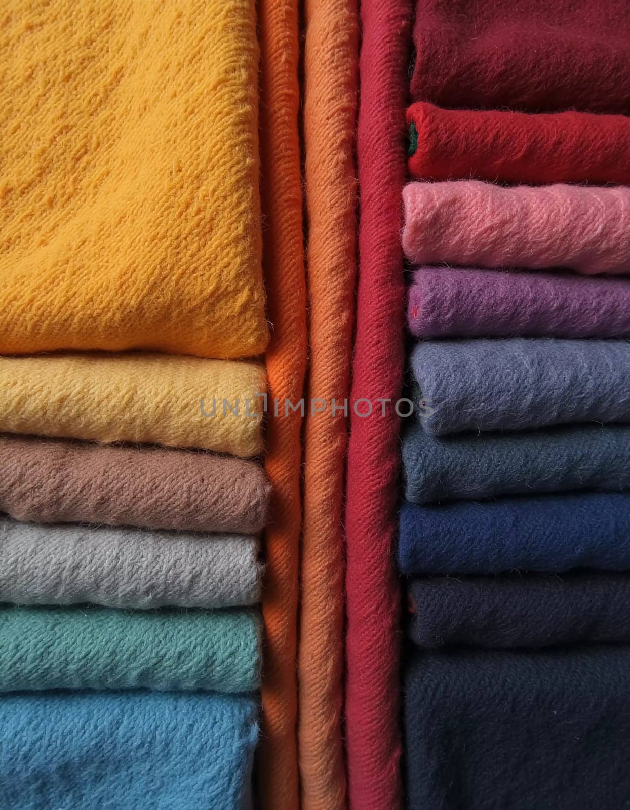 Various samples of woolen fabric in different colors are neatly organized, showcasing a vibrant palette ideal for textile design and creative projects. Generative AI.