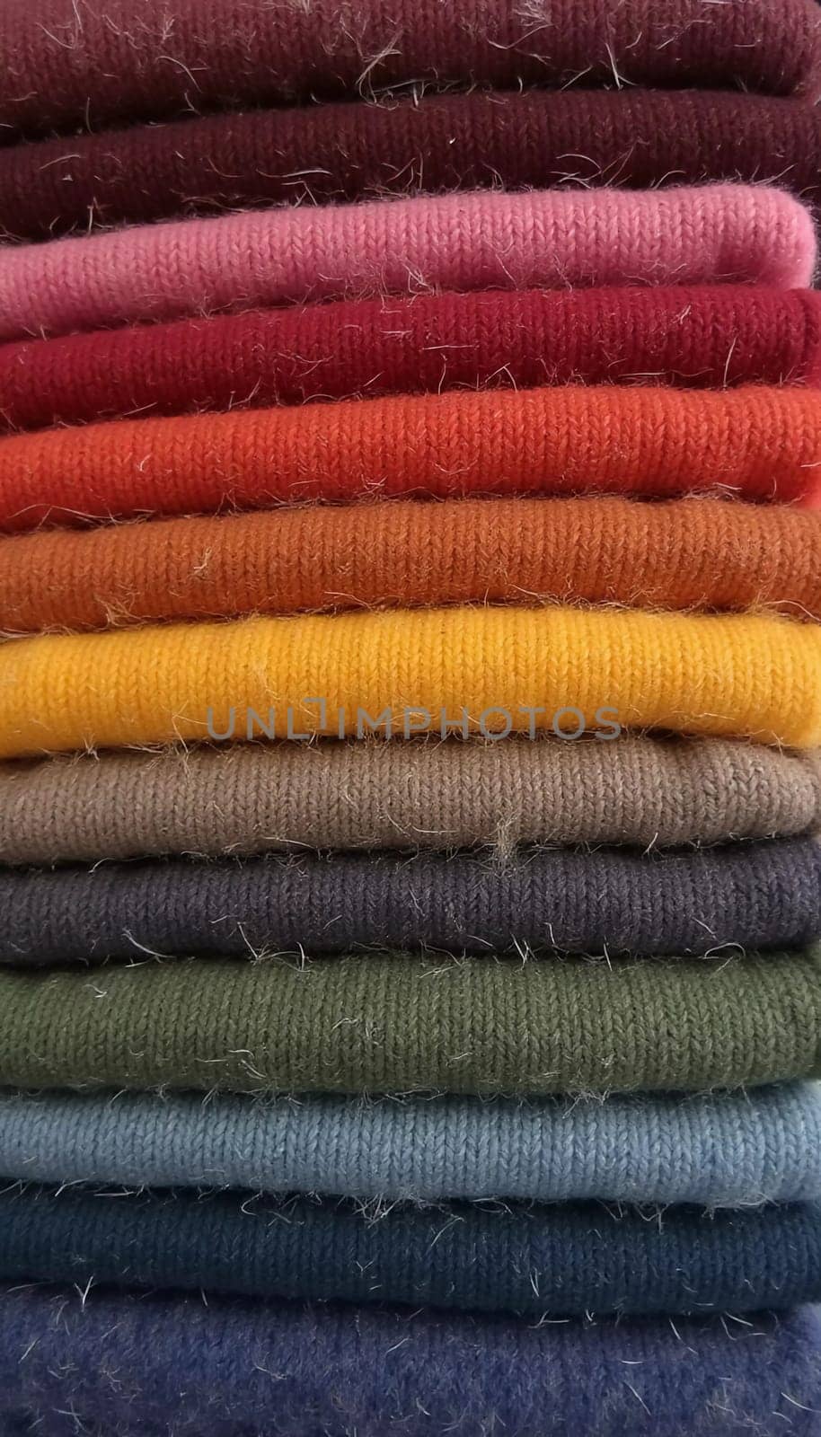 Various samples of woolen fabric in different colors are neatly organized, showcasing a vibrant palette ideal for textile design and creative projects. Generative AI.