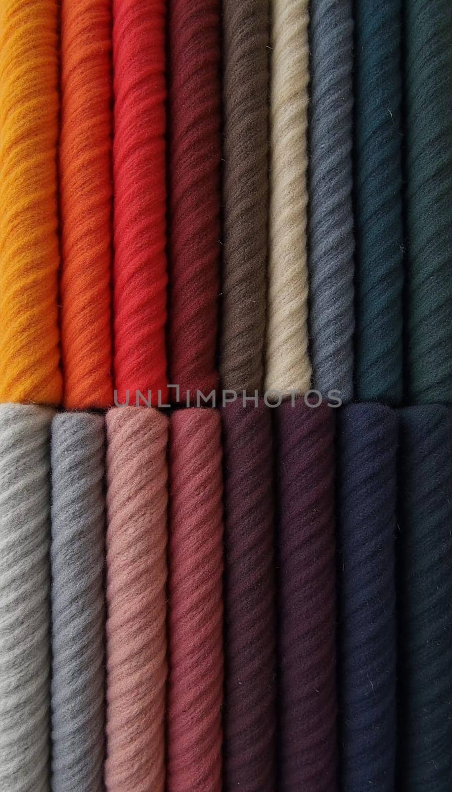 Various samples of woolen fabric in different colors are neatly organized, showcasing a vibrant palette ideal for textile design and creative projects. Generative AI.