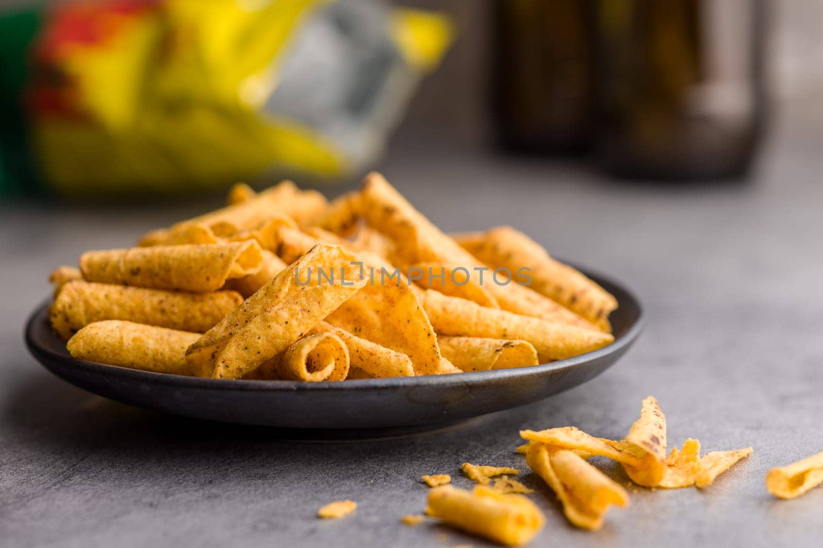 Rolled nachos tortilla chips on plate on a kitchen table.