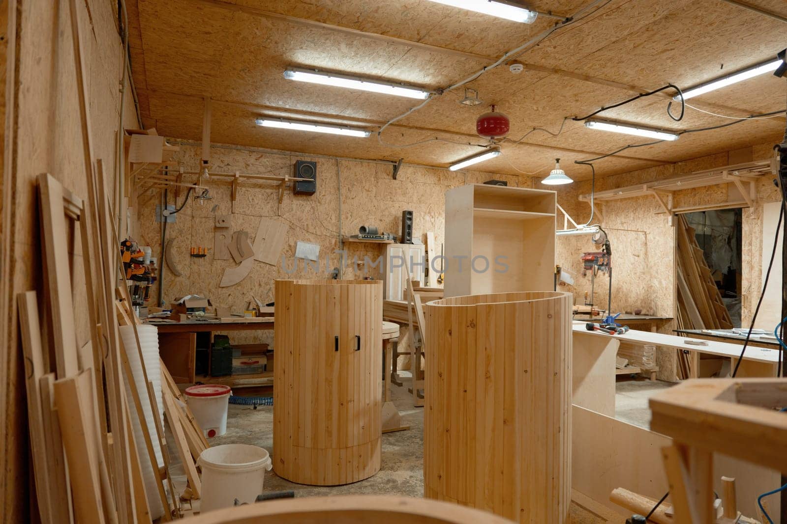 Small woodworking business and industry. Carpentry workshop interior for successful production of new wooden furniture, mini saunas